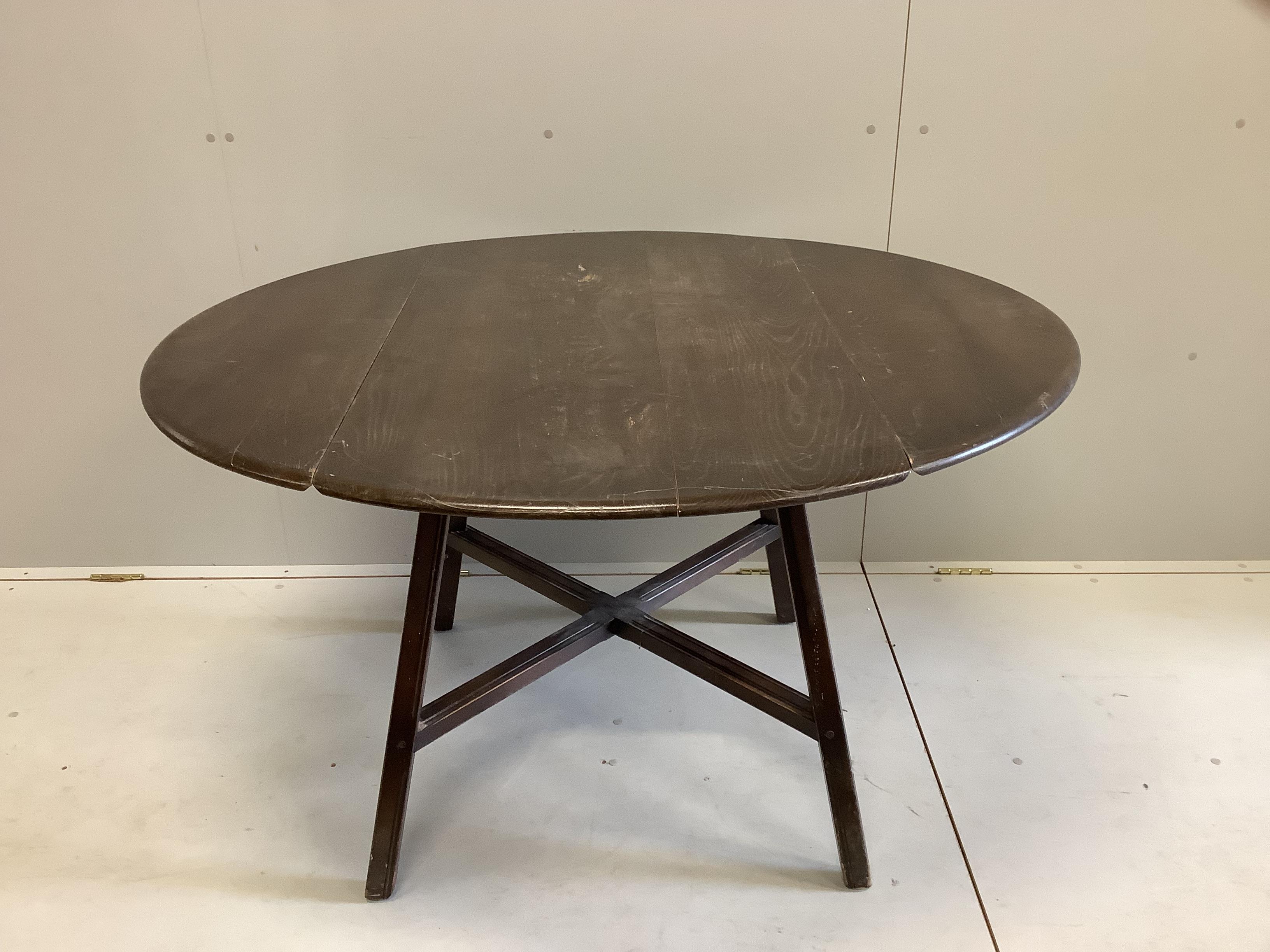 An Ercol elm drop leaf dining table, 124cm extended, width 112cm, height 71cm and six Ercol elm and beech dining chairs (two with arms)